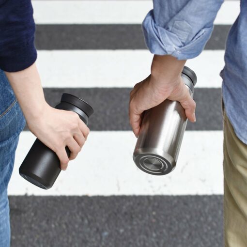 kinto travel cups in hand