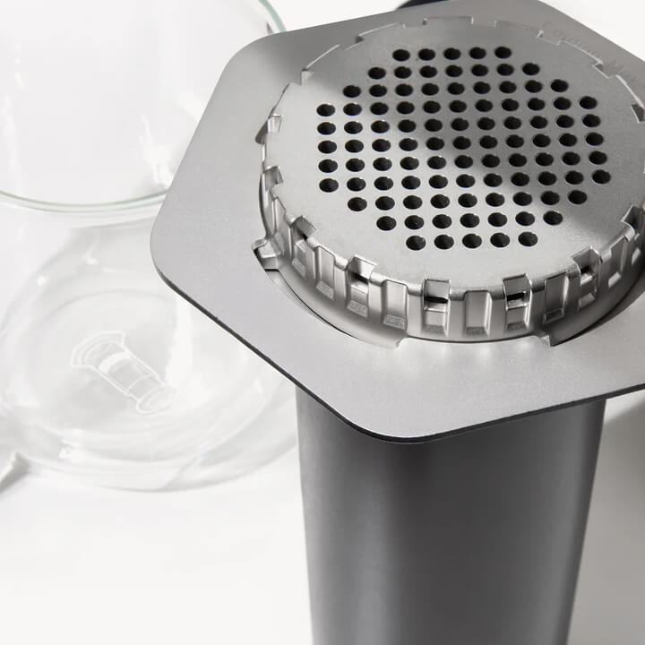 Aeropress Steel coffee maker in black stainless steel on a white background