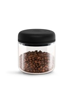Fellow Atmos Vacuum Canister in clear glass with black vacuum lid, filled with coffee beans