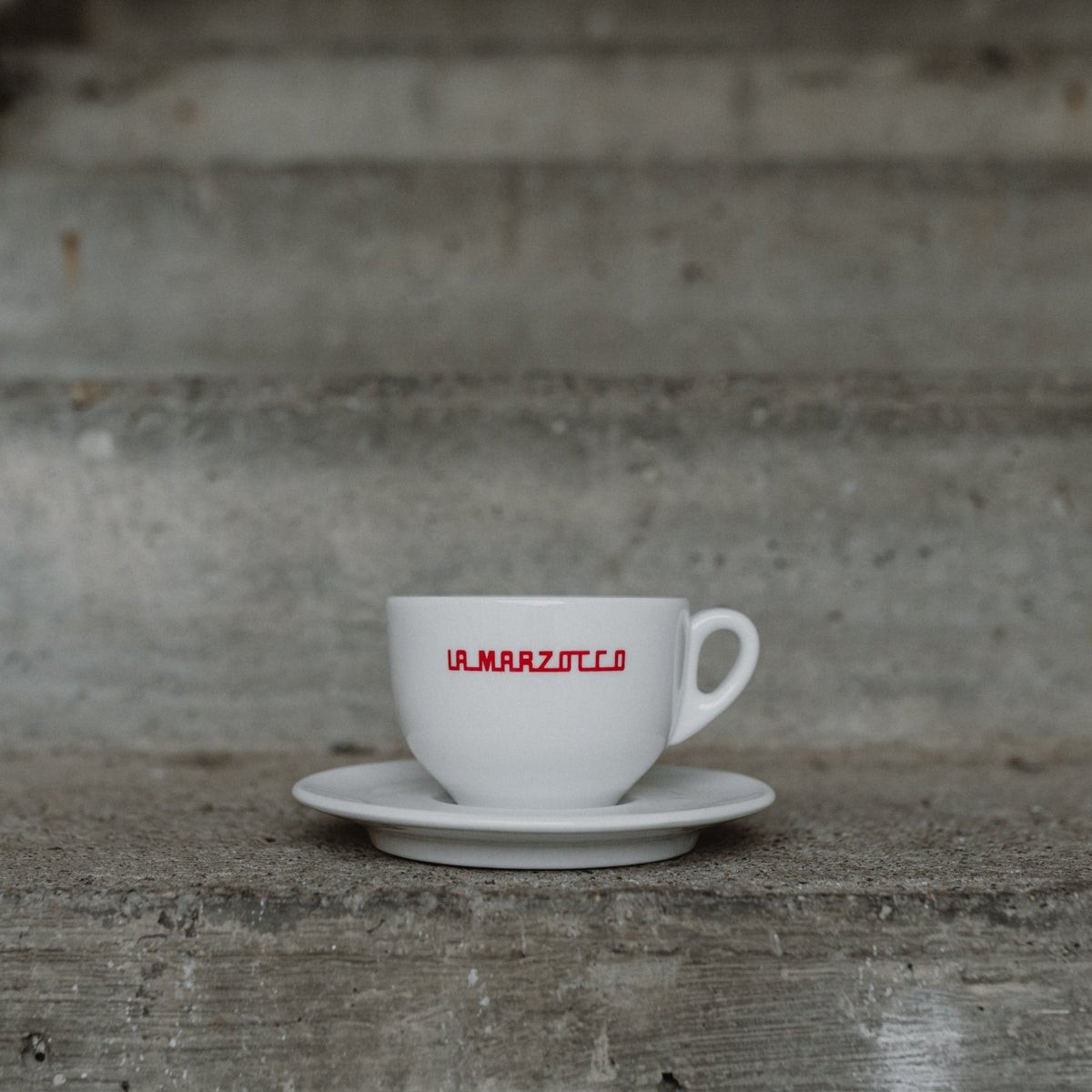 La Marzocco Linea cappuccino cup with red Linea logo and saucer