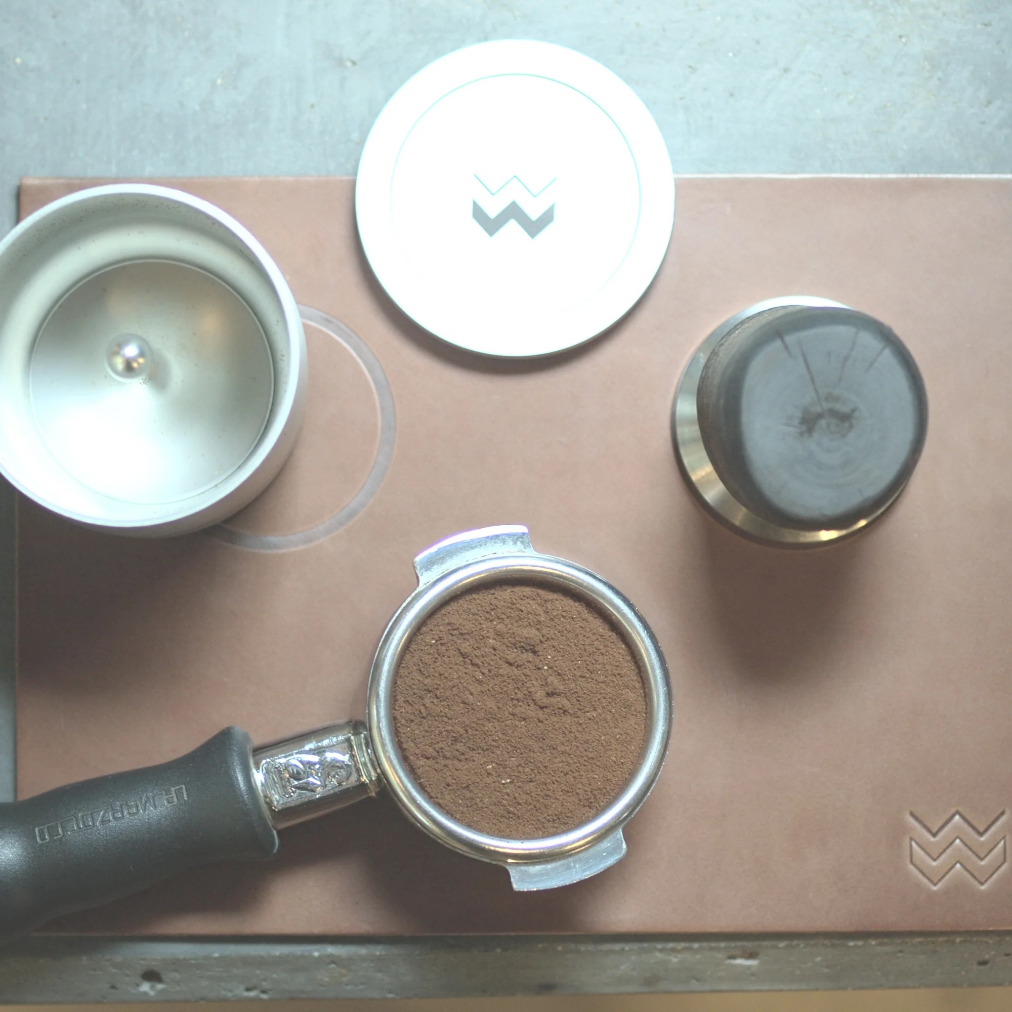 Natural Weber Workshops leather tamping mat with portafilter, tamper and Blind Shaker, seen from above